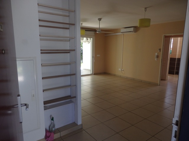 Entrée du T3 avec meuble à chaussures et vue sur la pièce à vivre et le couloir d'accès au coin nuit